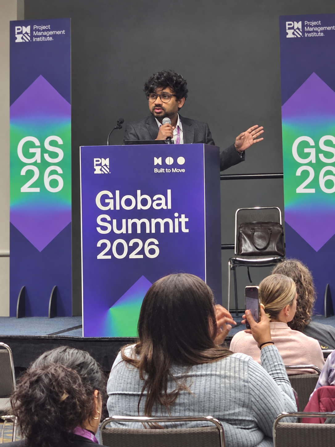 Pradeep Billa speaking onstage at PMI Global Summit 2026 in Detroit